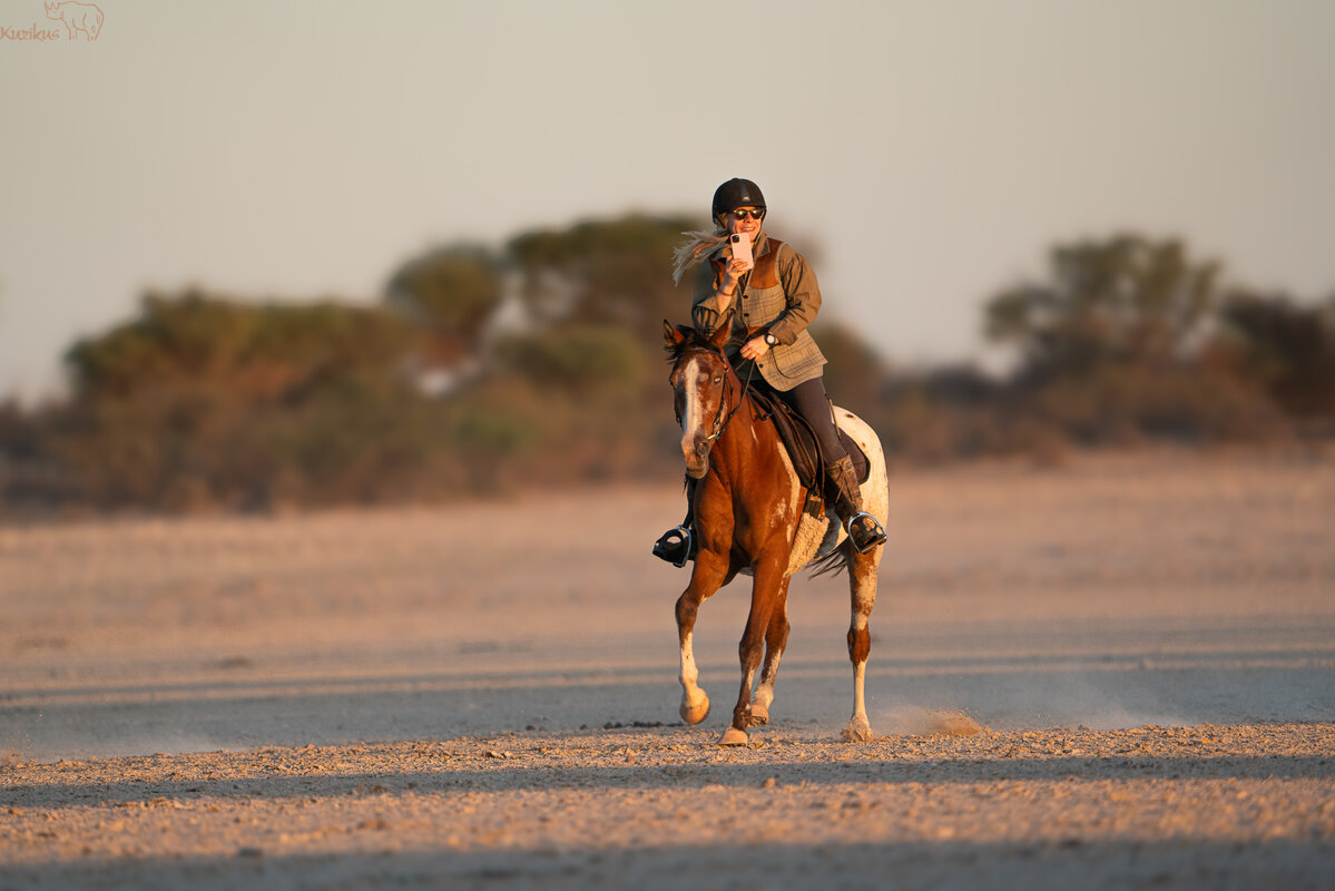 Rider taking pictures from the horse in the salt pan